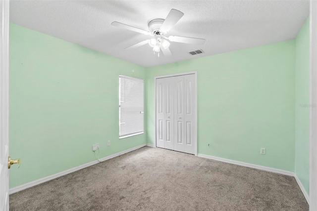 2790 Pelham Cir, Deltona, FL 32738 - unfurnished bedroom featuring carpet floors, a closet, a textured ceiling, and ceiling fan