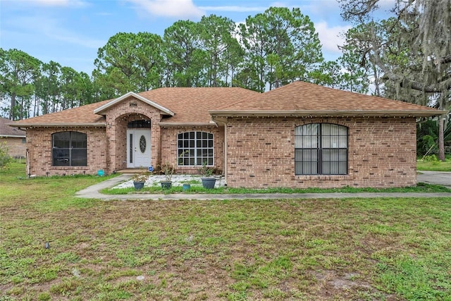 2790 Pelham Cir, Deltona, FL 32738 - ranch-style house with a front lawn, roof with shingles, and brick siding