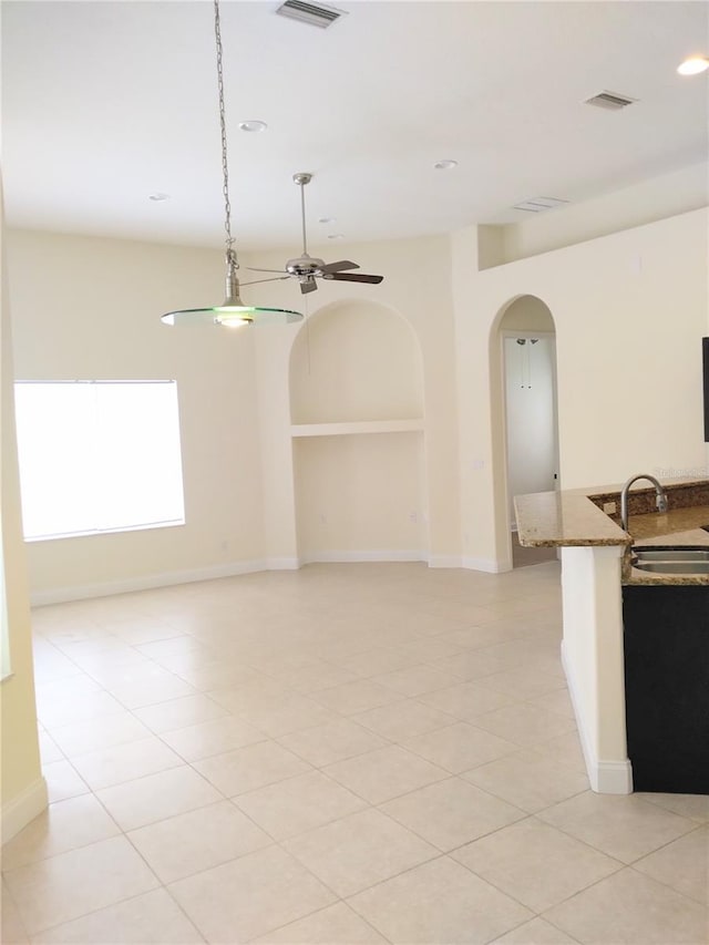 28 Front St, Palm Coast, FL 32137 - unfurnished room featuring arched walkways, ceiling fan, built in features, and recessed lighting