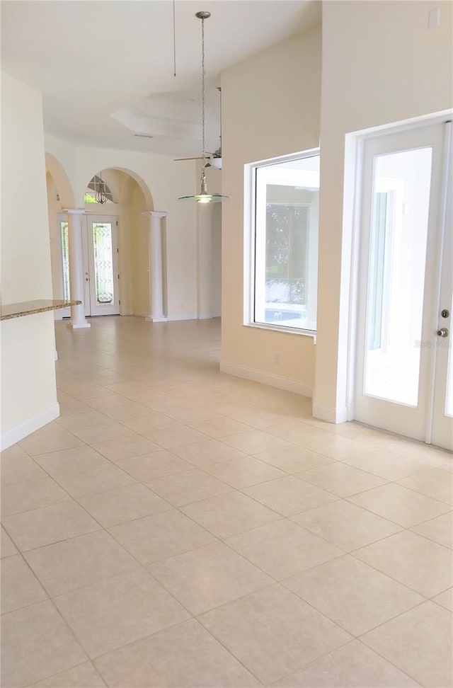 28 Front St, Palm Coast, FL 32137 - unfurnished room featuring arched walkways, light tile patterned floors, decorative columns, and french doors