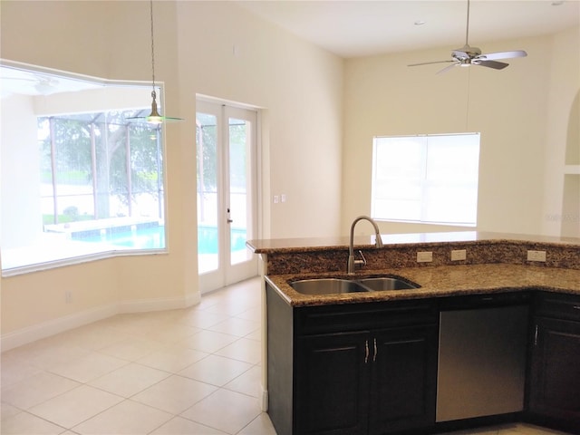 28 Front St, Palm Coast, FL 32137 - kitchen featuring french doors, dark cabinets, dark stone counters, and dishwasher