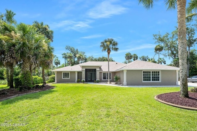 3959 S Chinook Ln, Ormond Beach, FL 32174 - back of house with stucco siding and a lawn