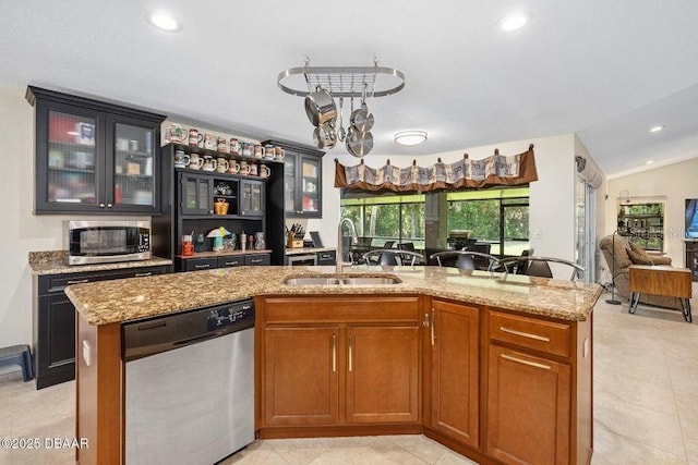 3959 S Chinook Ln, Ormond Beach, FL 32174 - kitchen featuring stainless steel appliances, light stone counters, open floor plan, glass insert cabinets, and recessed lighting