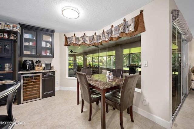 3959 S Chinook Ln, Ormond Beach, FL 32174 - dining room with wine cooler, bar, a textured ceiling, and light tile patterned floors