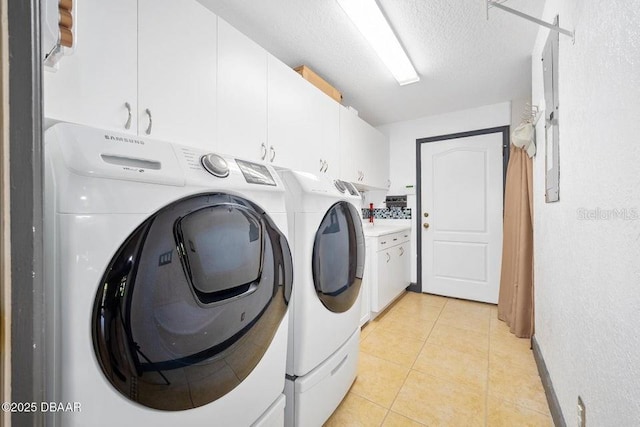 3959 S Chinook Ln, Ormond Beach, FL 32174 - laundry area with cabinet space, independent washer and dryer, light tile patterned flooring, and a textured ceiling