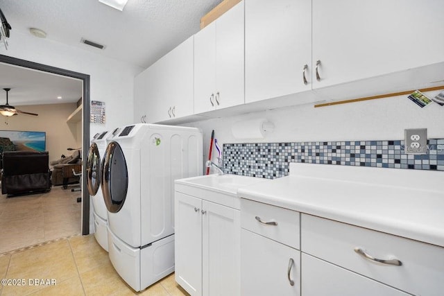3959 S Chinook Ln, Ormond Beach, FL 32174 - laundry area featuring separate washer and dryer, cabinet space, ceiling fan, and light tile patterned floors