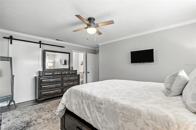16 Courtney Pl, Palm Coast, FL 32137 - bedroom featuring wood finished floors, a barn door, ornamental molding, a textured ceiling, and ceiling fan