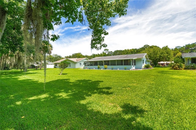 16 Courtney Pl, Palm Coast, FL 32137 - view of grassy yard with a sunroom