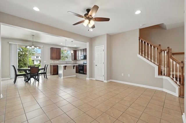 176 Nelson Ln, Saint Johns, FL 32259 - living area featuring ceiling fan, stairway, light tile patterned floors, recessed lighting, and a chandelier