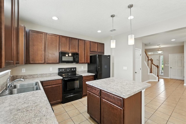176 Nelson Ln, Saint Johns, FL 32259 - kitchen with black appliances, light tile patterned floors, light countertops, hanging light fixtures, and a kitchen island