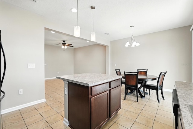 176 Nelson Ln, Saint Johns, FL 32259 - kitchen featuring light tile patterned floors, light countertops, ceiling fan, dark brown cabinetry, and recessed lighting