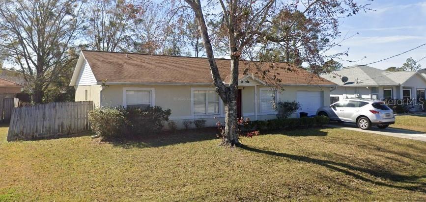 20 Prince Anthony Ln, Palm Coast, FL 32164 - ranch-style house with an attached garage, stucco siding, and concrete driveway
