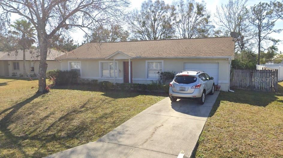 20 Prince Anthony Ln, Palm Coast, FL 32164 - single story home with driveway, an attached garage, and stucco siding
