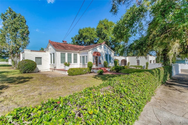 mediterranean / spanish home with a front yard