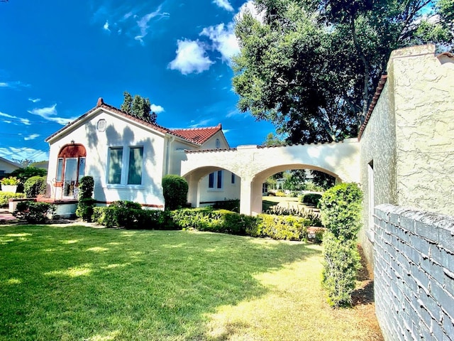 mediterranean / spanish-style house featuring a front lawn