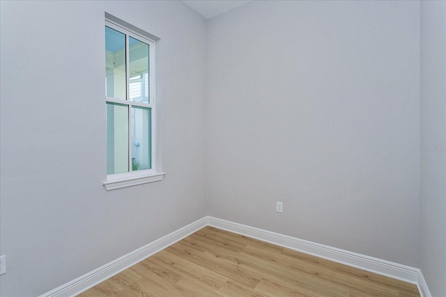 unfurnished room with light wood finished floors and baseboards