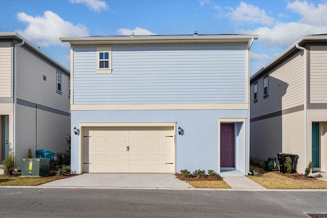 view of front of property featuring driveway, an attached garage, cooling unit, and stucco siding