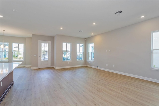 unfurnished living room featuring light wood-type flooring, visible vents, and recessed lighting