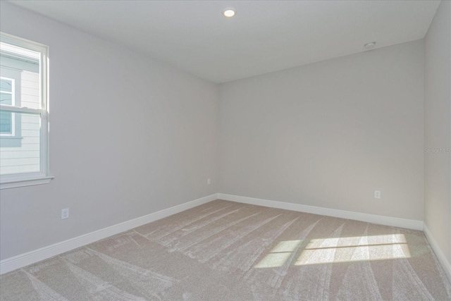 empty room featuring baseboards, carpet flooring, and recessed lighting