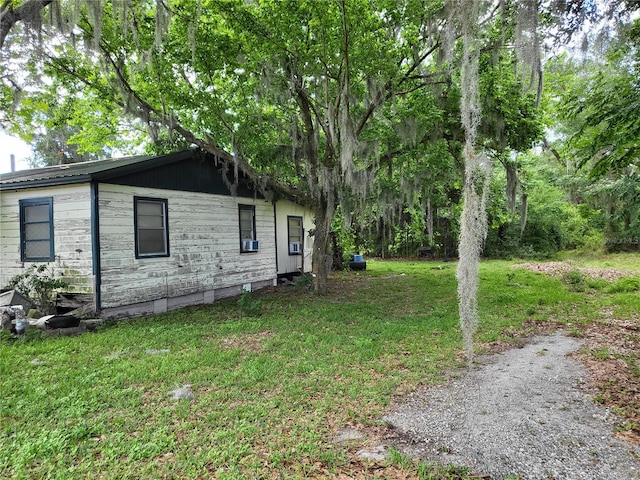 view of side of home featuring a lawn