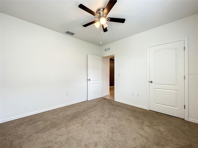 unfurnished bedroom with dark carpet and ceiling fan