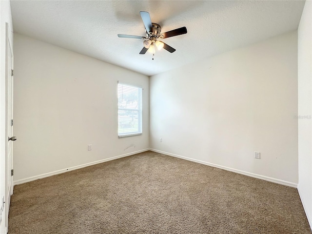 carpeted empty room featuring ceiling fan and a textured ceiling