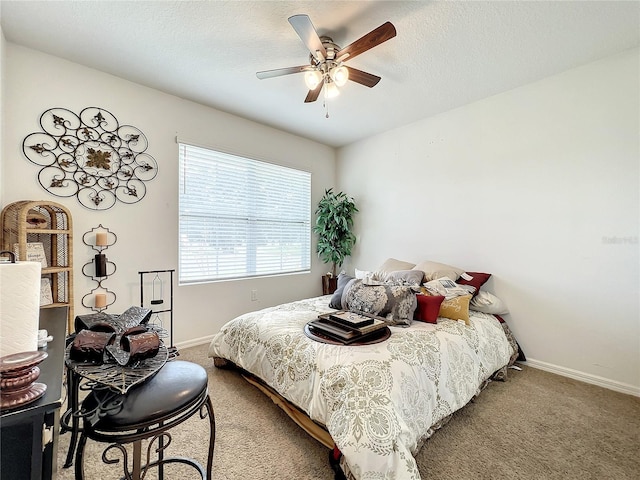 bedroom featuring a textured ceiling, carpet, and ceiling fan