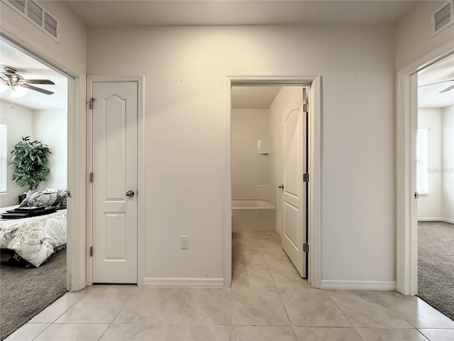 hallway with light colored carpet