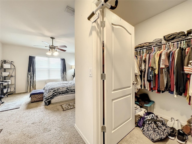 spacious closet featuring light carpet and ceiling fan