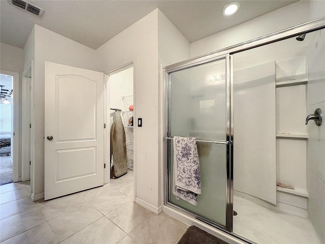 bathroom featuring walk in shower and tile flooring