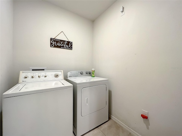 laundry area with light tile flooring and independent washer and dryer