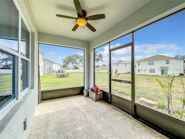 sunroom / solarium featuring ceiling fan