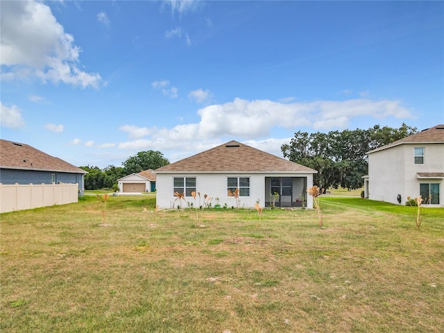 back of house with a lawn