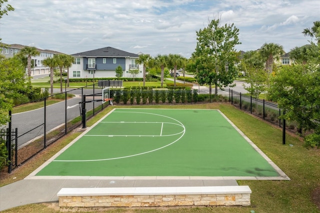 view of basketball court featuring community basketball court, a yard, and fence