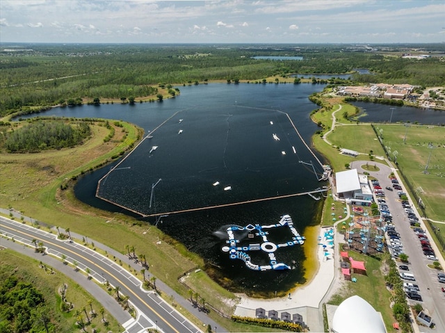 birds eye view of property with a forest view and a water view