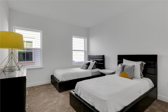 carpeted bedroom with multiple windows