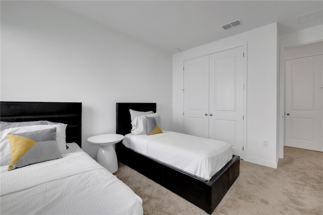 carpeted bedroom featuring a closet