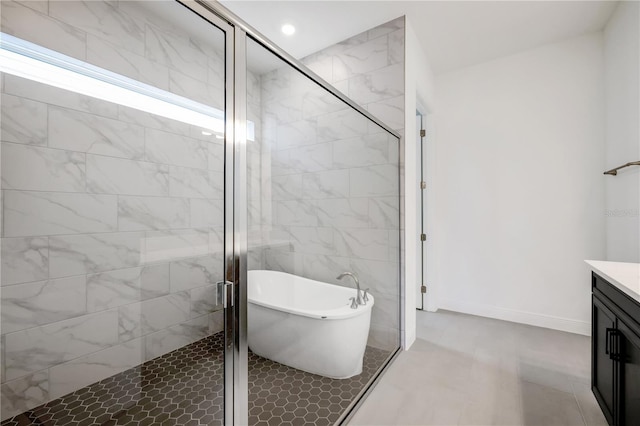 bathroom featuring vanity and independent shower and bath