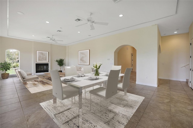 tiled dining room featuring ceiling fan