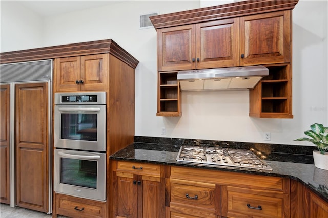 kitchen featuring dark stone countertops and appliances with stainless steel finishes