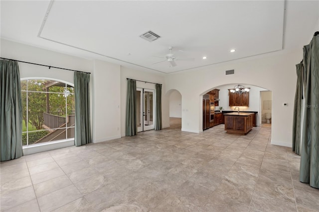 interior space with ceiling fan with notable chandelier and sink