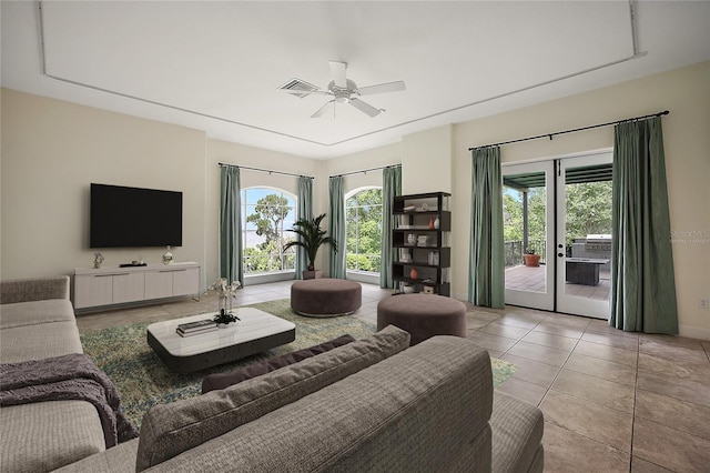 living room with light tile floors, ceiling fan, and french doors