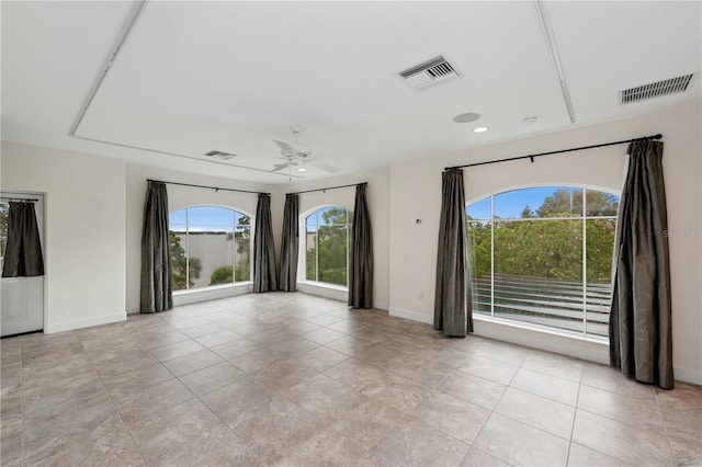 unfurnished room with light tile floors and ceiling fan