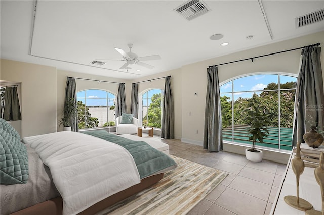 bedroom with multiple windows, ceiling fan, and light tile flooring