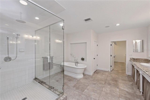 bathroom with vanity, tile flooring, and plus walk in shower