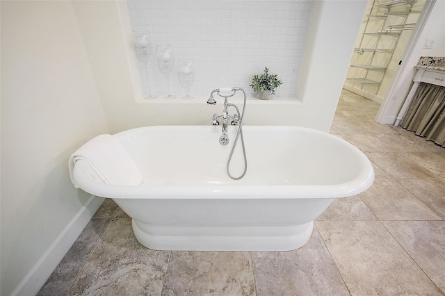 bathroom with a bath and tile floors