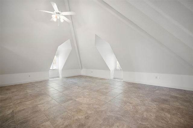 additional living space with light tile floors, vaulted ceiling, and ceiling fan