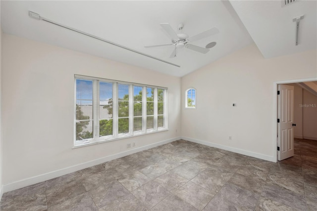 spare room featuring vaulted ceiling, ceiling fan, and light tile flooring