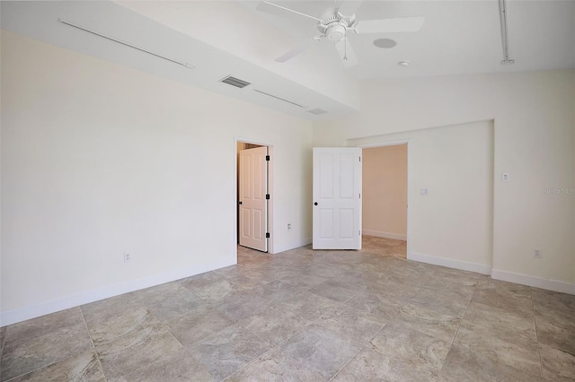 unfurnished room with light tile flooring, lofted ceiling, and ceiling fan