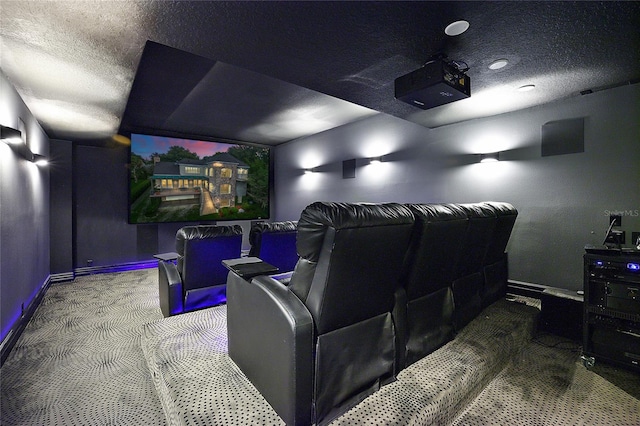 cinema room with dark colored carpet and a textured ceiling